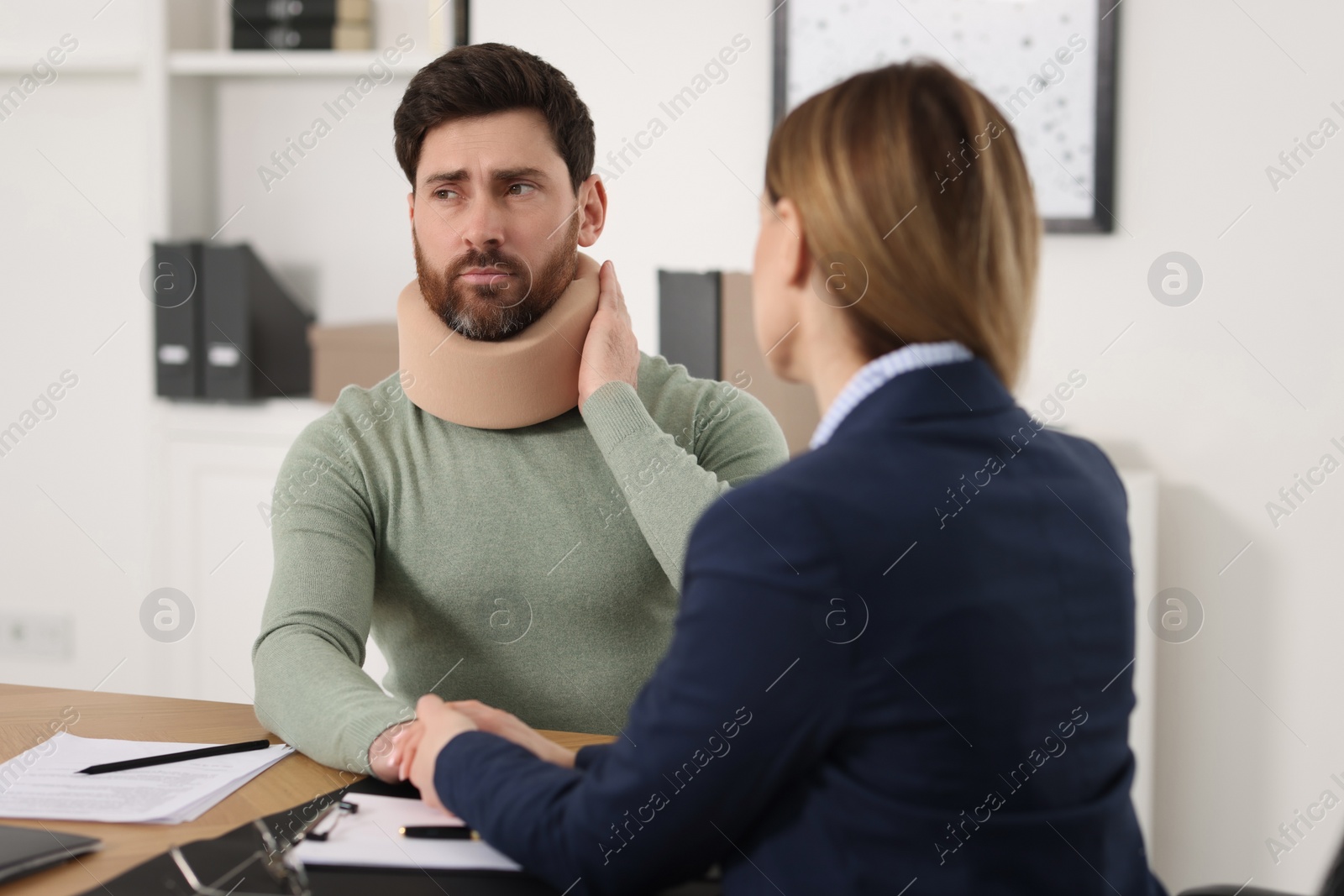 Photo of Injured woman having meeting with lawyer in office