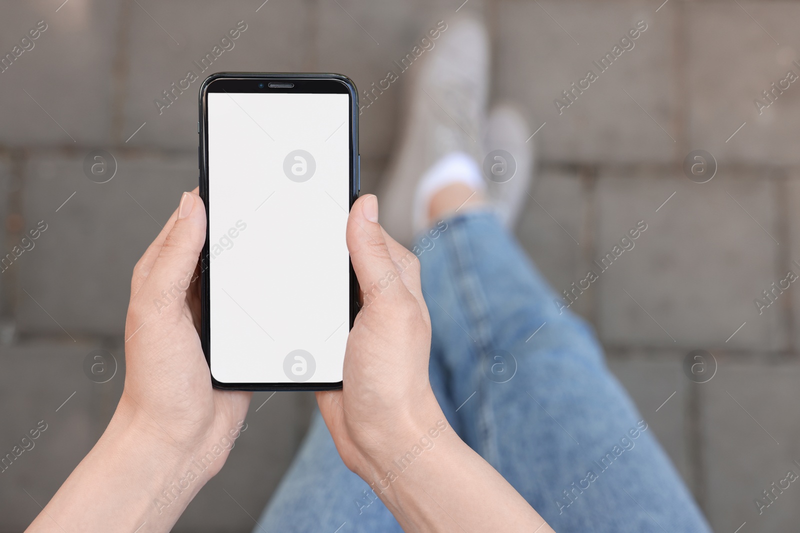 Photo of Woman using mobile phone outdoors, closeup. Space for text