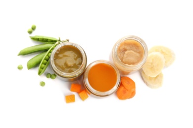 Jars with healthy baby food and ingredients on white background, top view