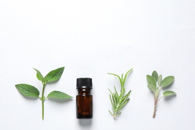 Bottle of essential oil, sage, rosemary and mint on white background, flat lay. Space for text