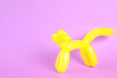 Photo of Animal figure made of modelling balloon on color background. Space for text