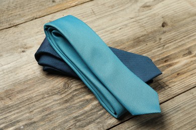 Photo of Two neckties on wooden table, above view
