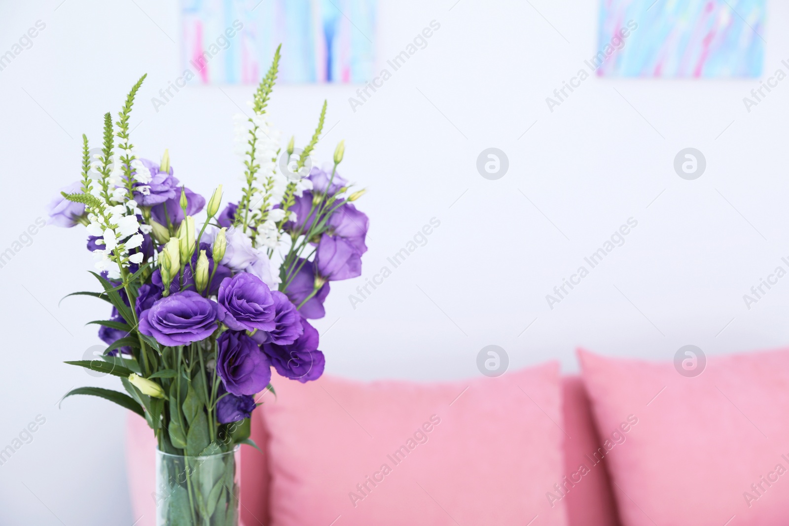 Photo of Vase with beautiful flowers on blurred background. Stylish interior