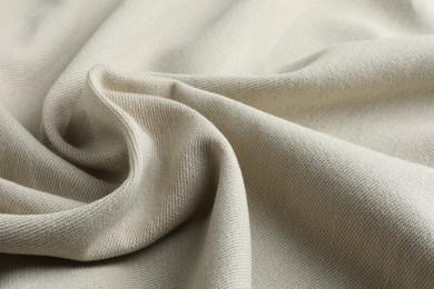 Texture of beige crumpled fabric as background, closeup