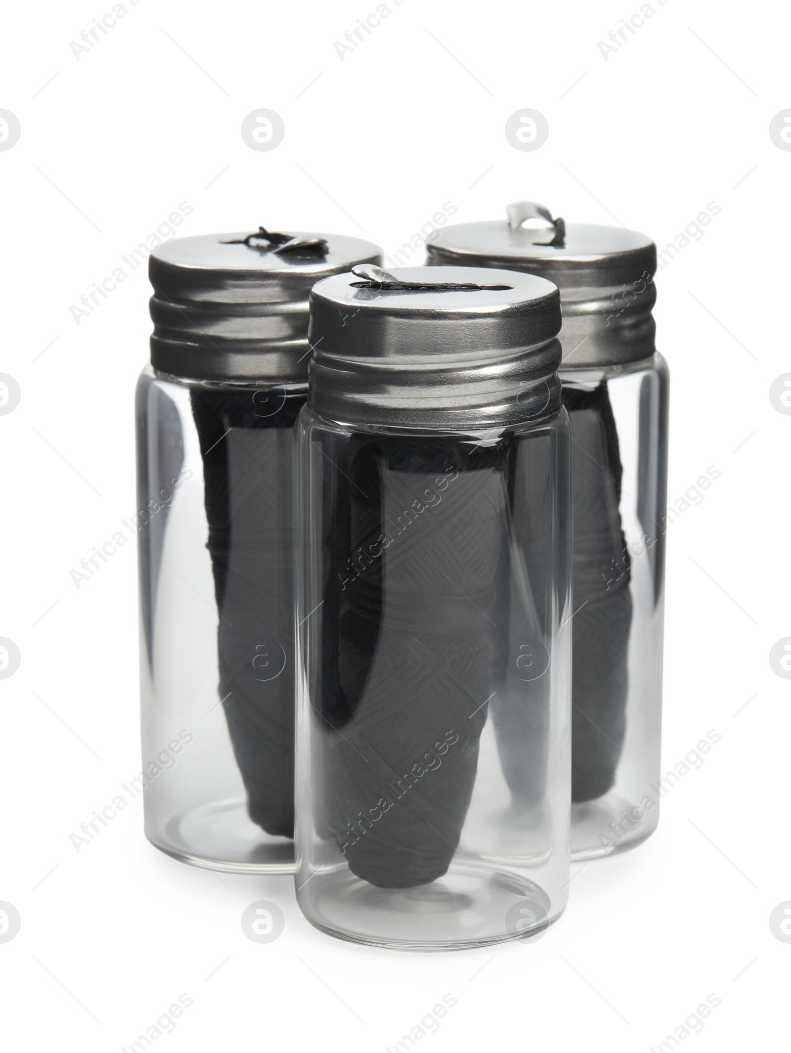 Photo of Rolls of natural organic dental floss in jars on white background