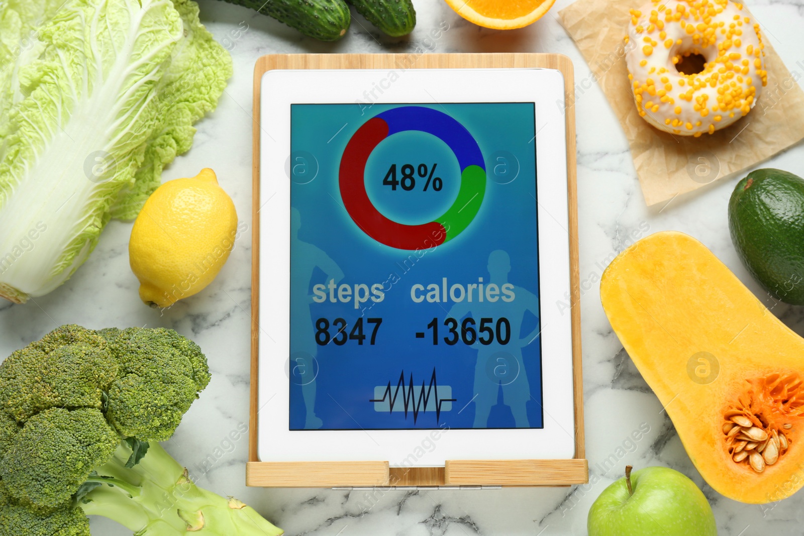 Photo of Tablet with weight loss calculator application and food products on white marble table, flat lay