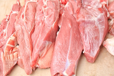 Photo of Pieces of fresh raw meat on counter in butcher shop