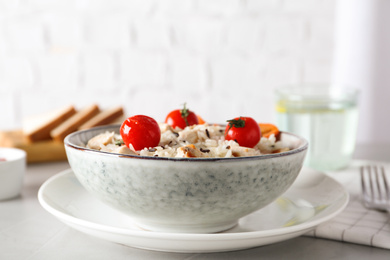 Delicious rice in bowl served on grey table