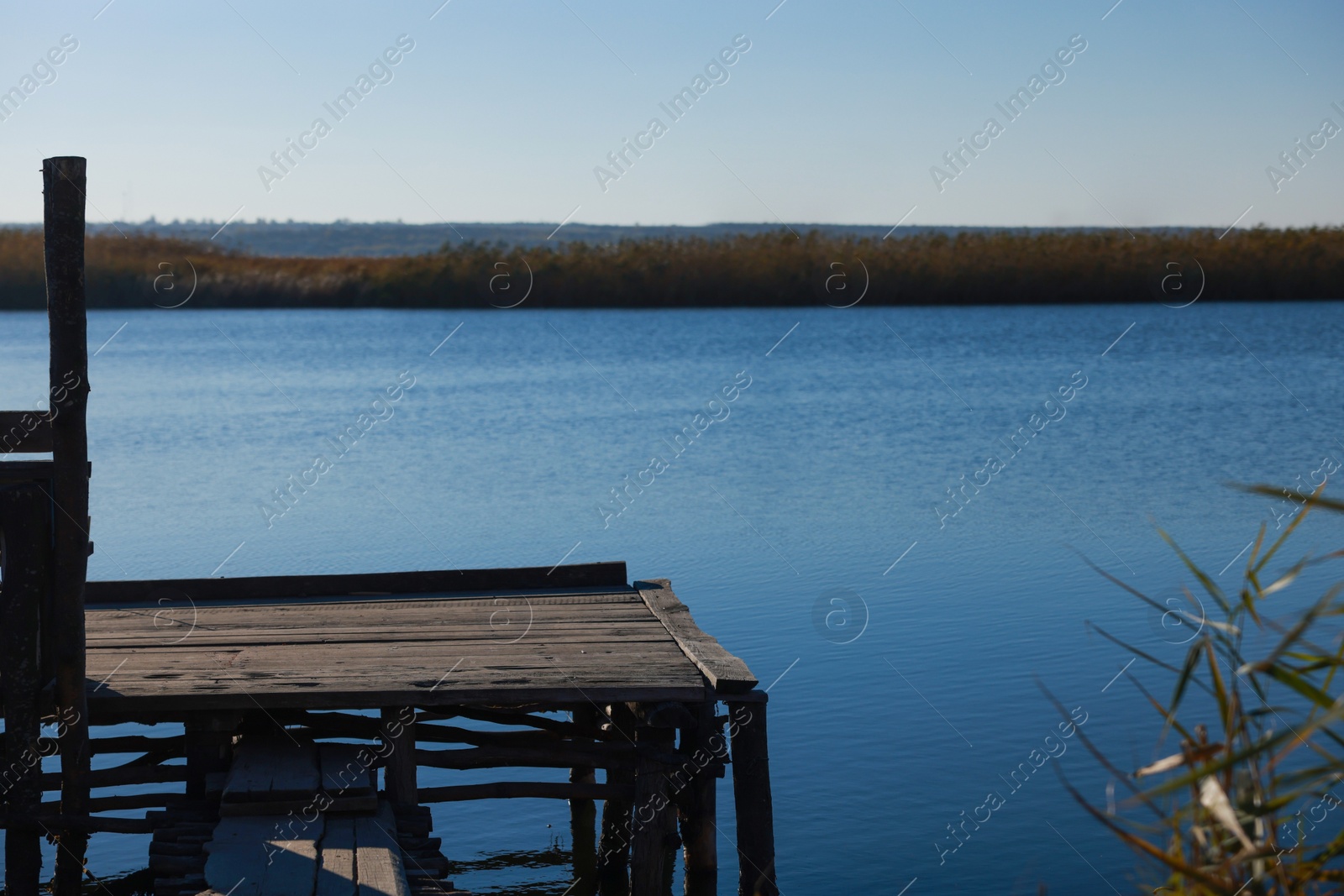 Photo of Beautiful view of river with wooden pier on sunny day