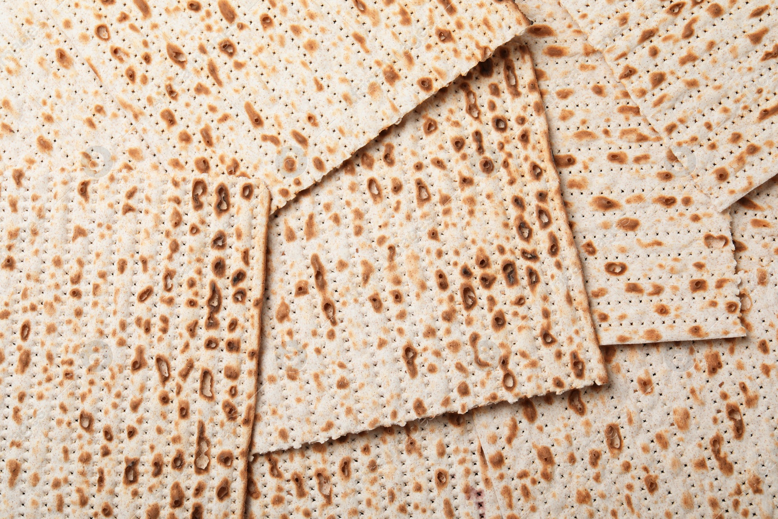 Photo of Traditional matzos as background, top view. Pesach celebration