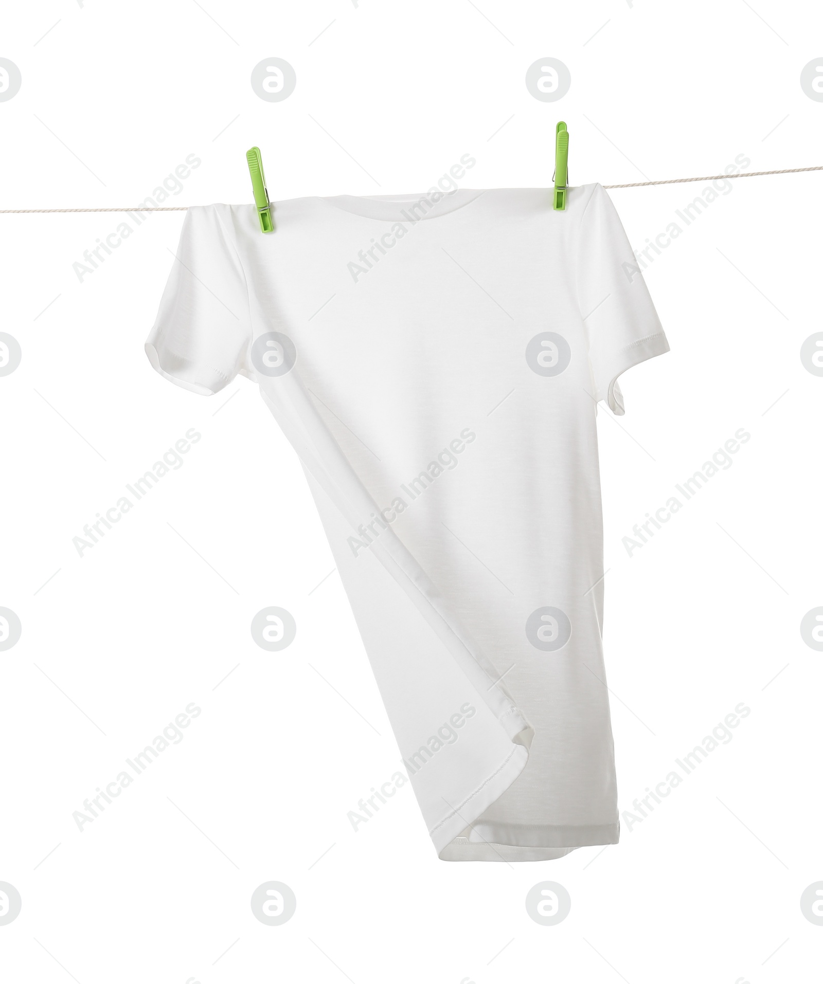 Photo of One t-shirt drying on washing line isolated on white