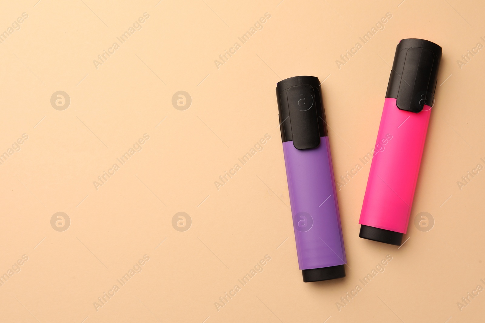 Photo of Bright color markers on beige background, flat lay. Space for text