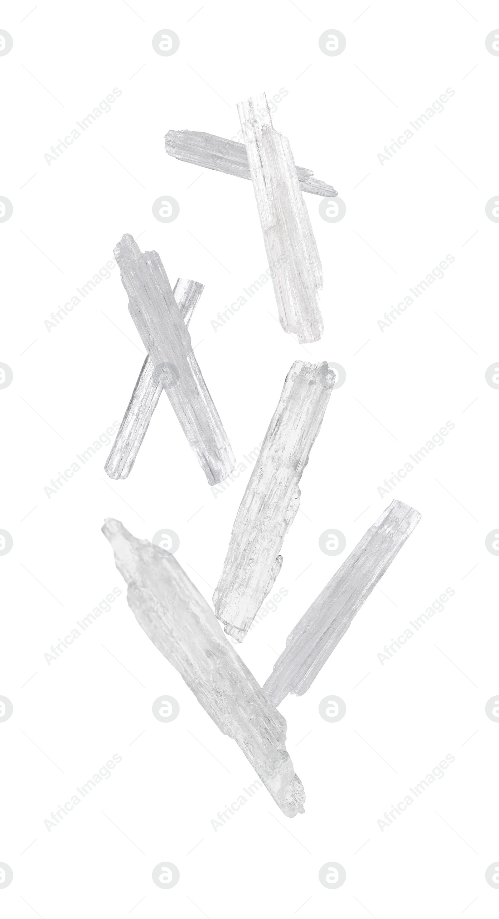 Image of Translucent menthol crystals falling on white background