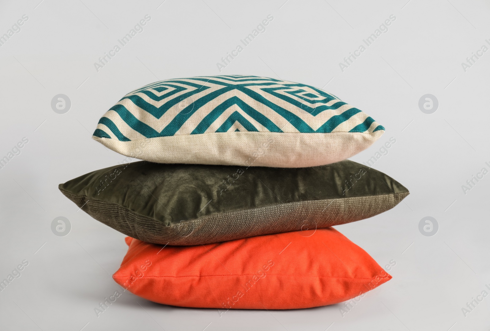 Photo of Stack of stylish soft pillows on grey background