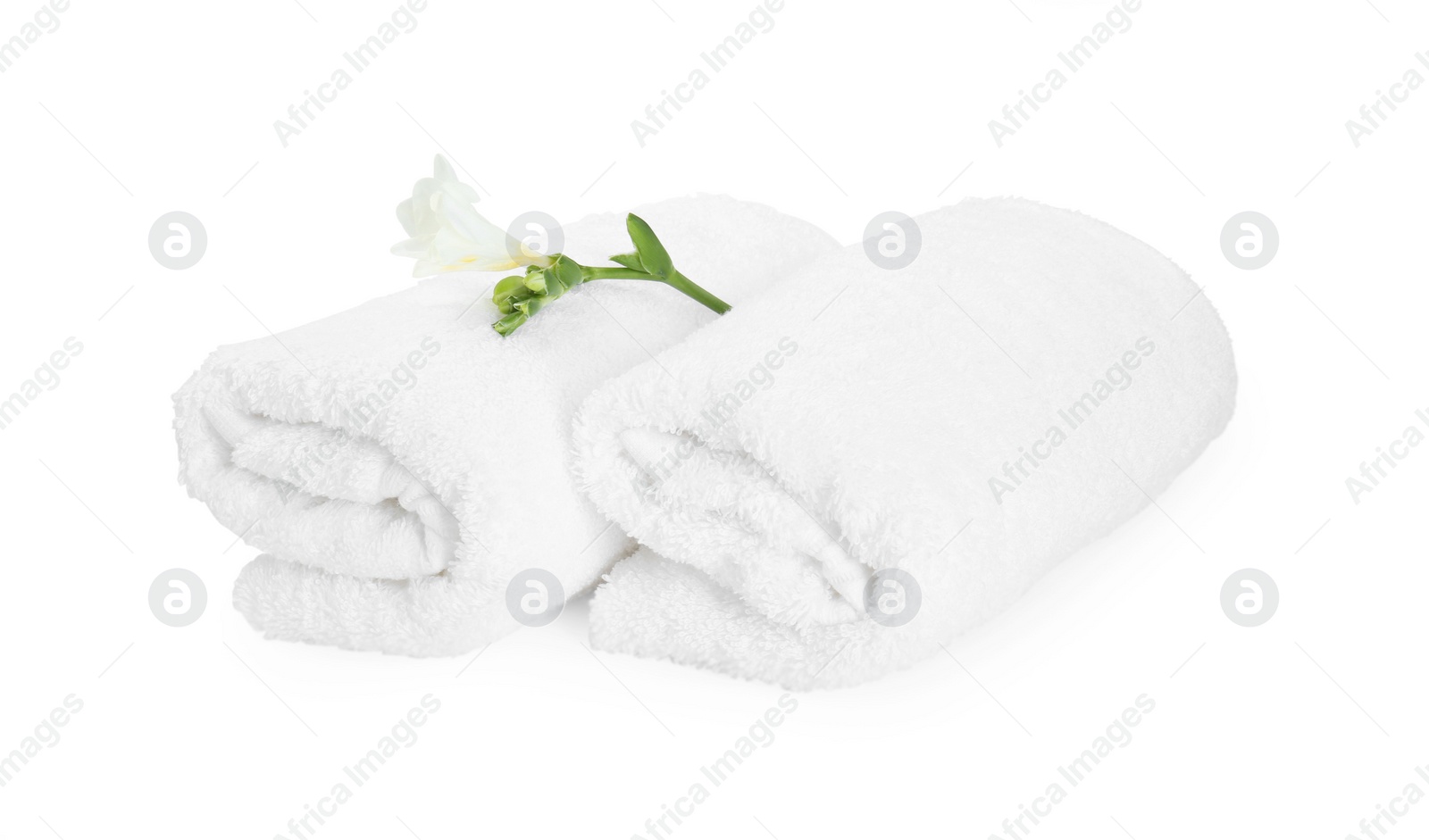 Photo of Terry towels and freesia flower isolated on white