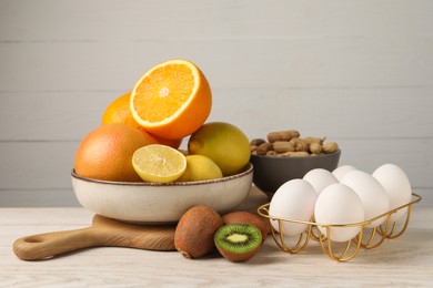 Photo of Allergenic food. Different fresh products on light wooden table