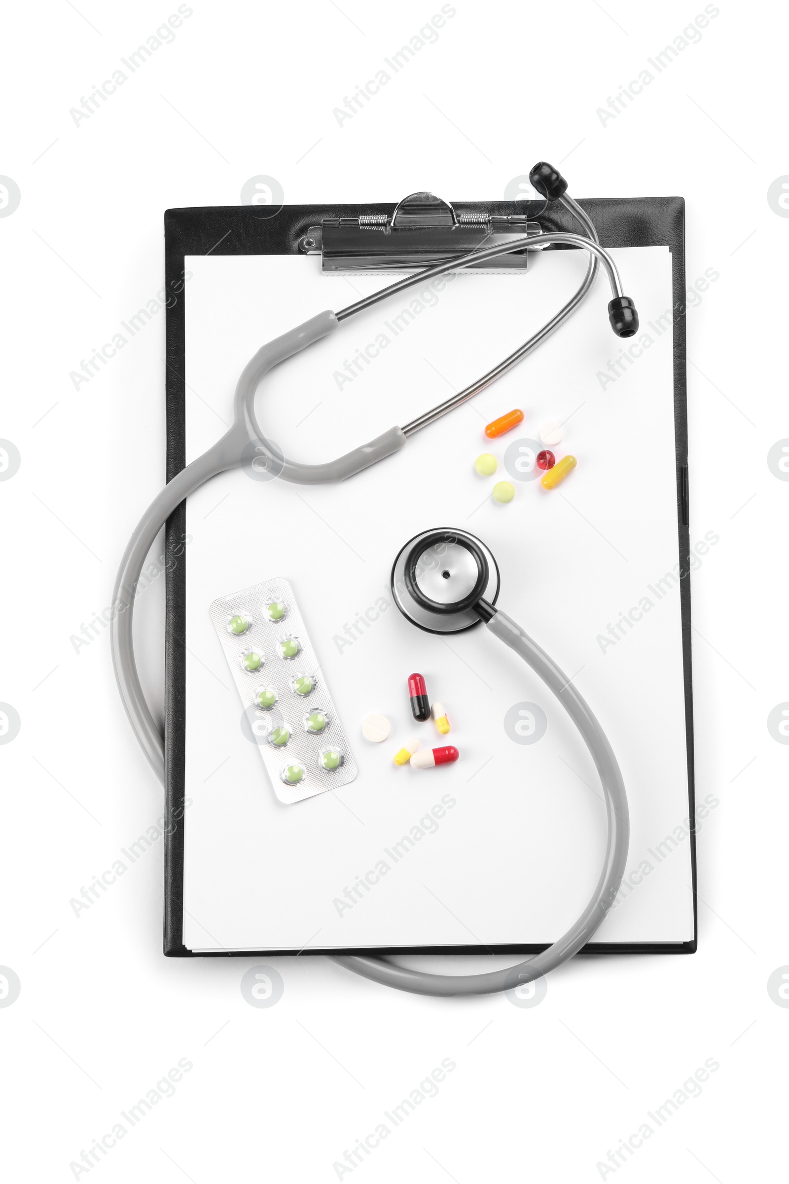 Photo of Stethoscope, pills and clipboard isolated on white, top view. Medical tool