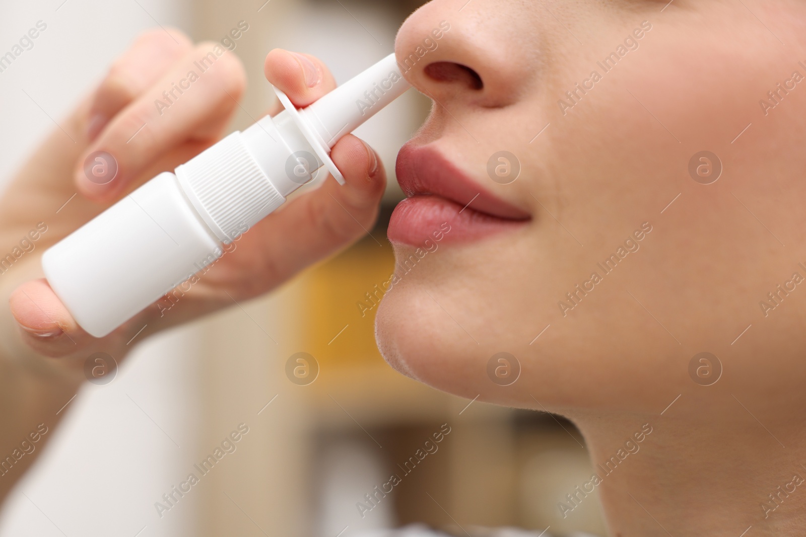 Photo of Medical drops. Woman using nasal spray at home, closeup