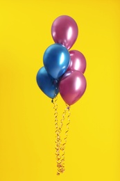 Bunch of bright balloons on color background