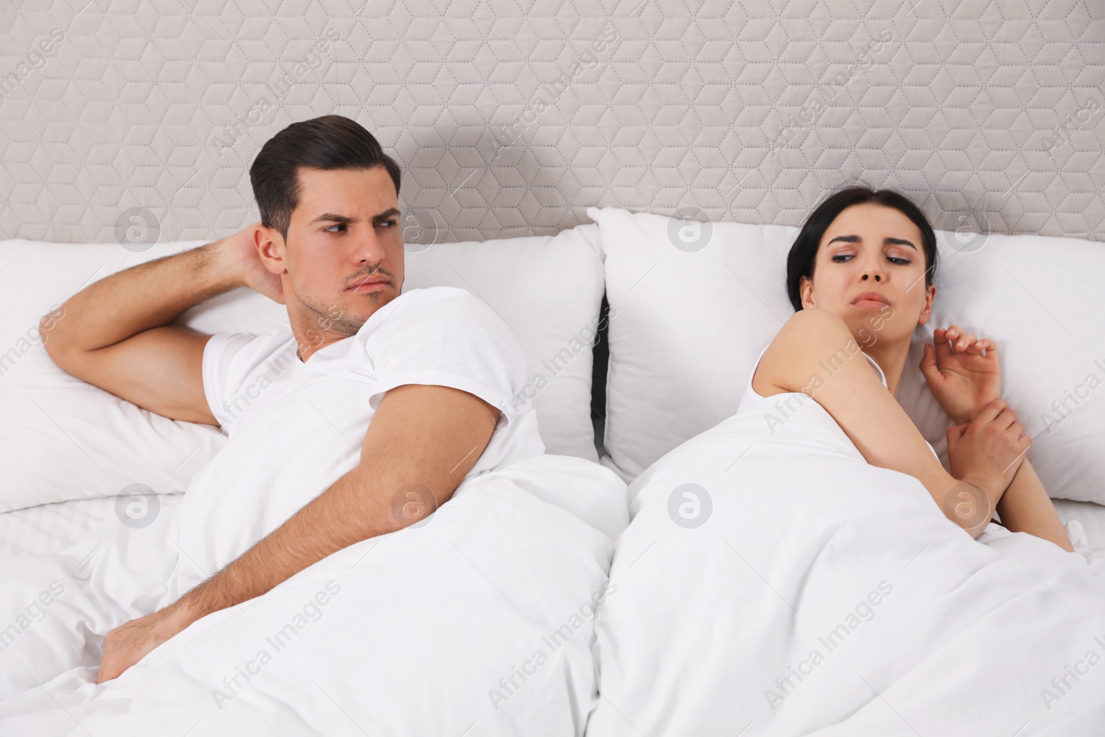Photo of Unhappy couple with relationship problems after quarrel in bed at home