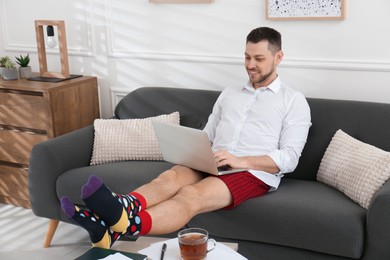 Businessman wearing shirt and underwear during video call at home