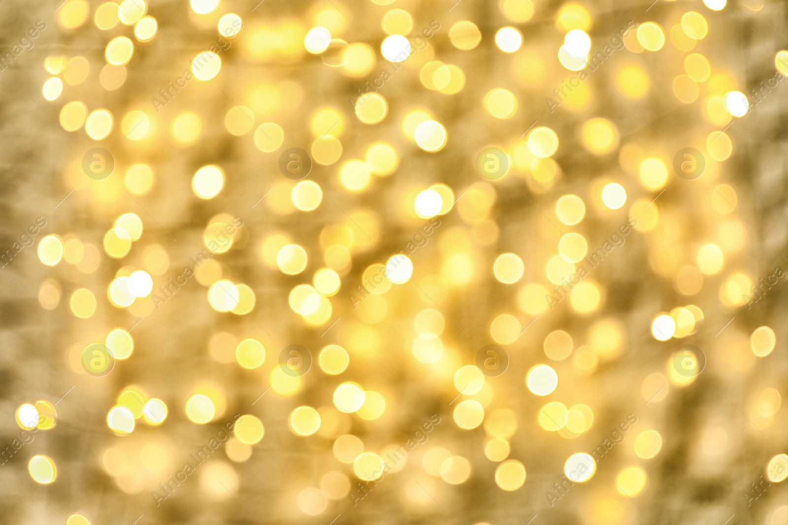 Photo of Blurred view of golden Christmas lights as background. Bokeh effect