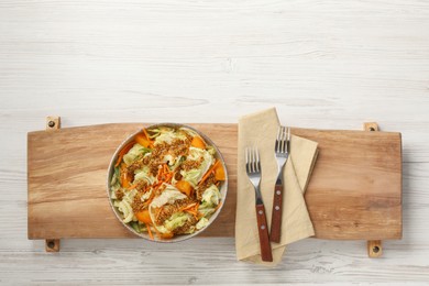 Photo of Delicious salad with Chinese cabbage and mustard seed dressing on white wooden table, top view