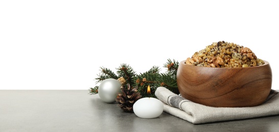 Photo of Traditional Christmas slavic dish kutia and festive decor on grey table against white background. Space for text