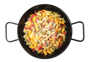 Colorful pasta with cheese in frying pan isolated on white, top view