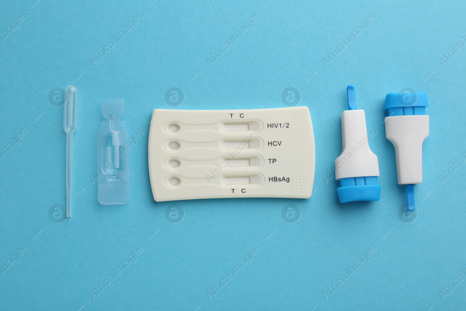 Photo of Disposable multi-infection express test kit on light blue background, flat lay