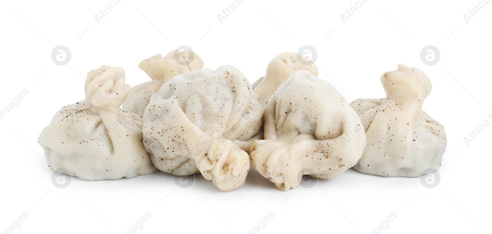 Photo of Many tasty khinkali (dumplings) and spices isolated on white. Georgian cuisine