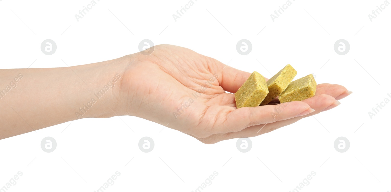 Photo of Woman holding bouillon cubes on white background, closeup
