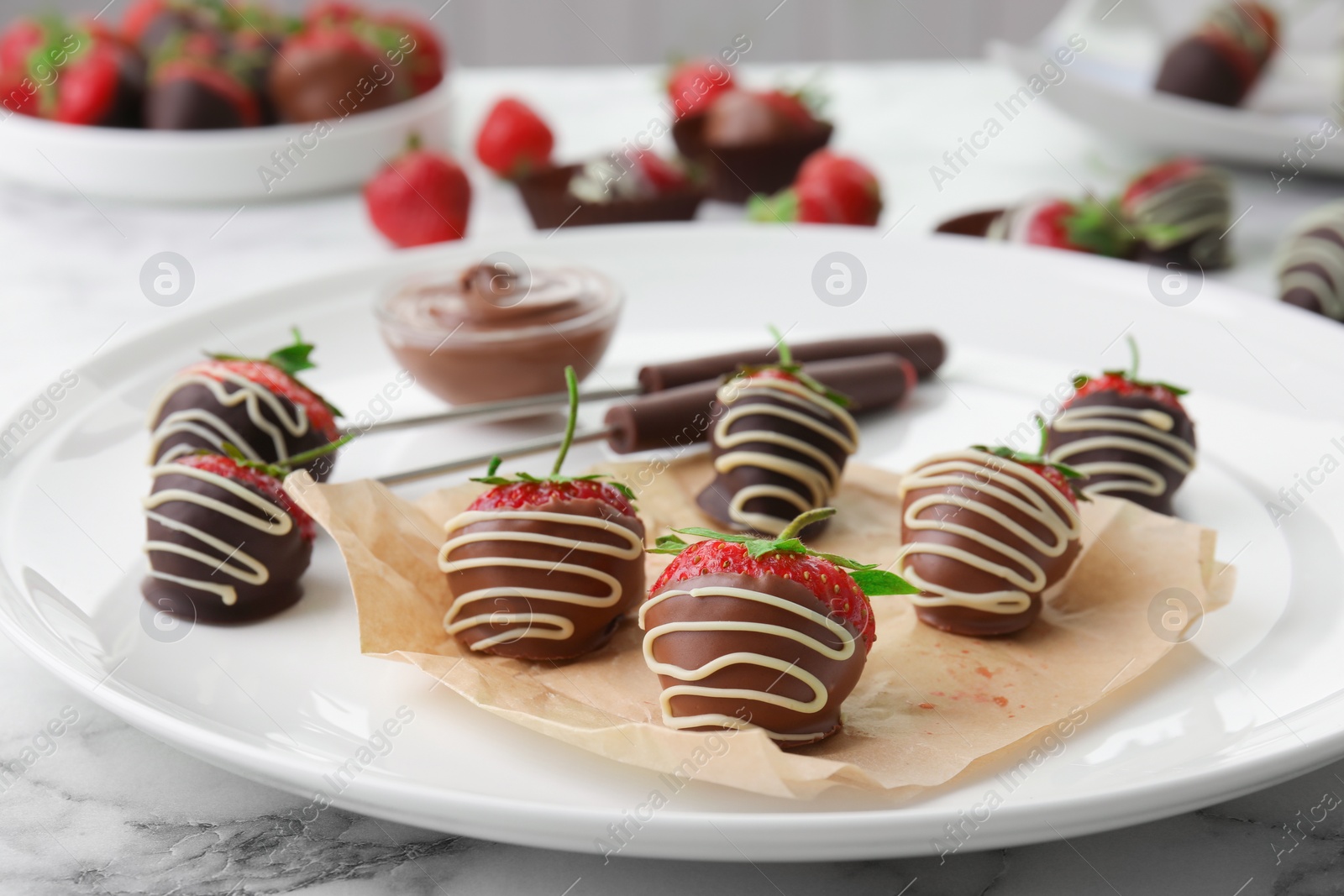 Photo of Plate with chocolate covered strawberries on table, closeup