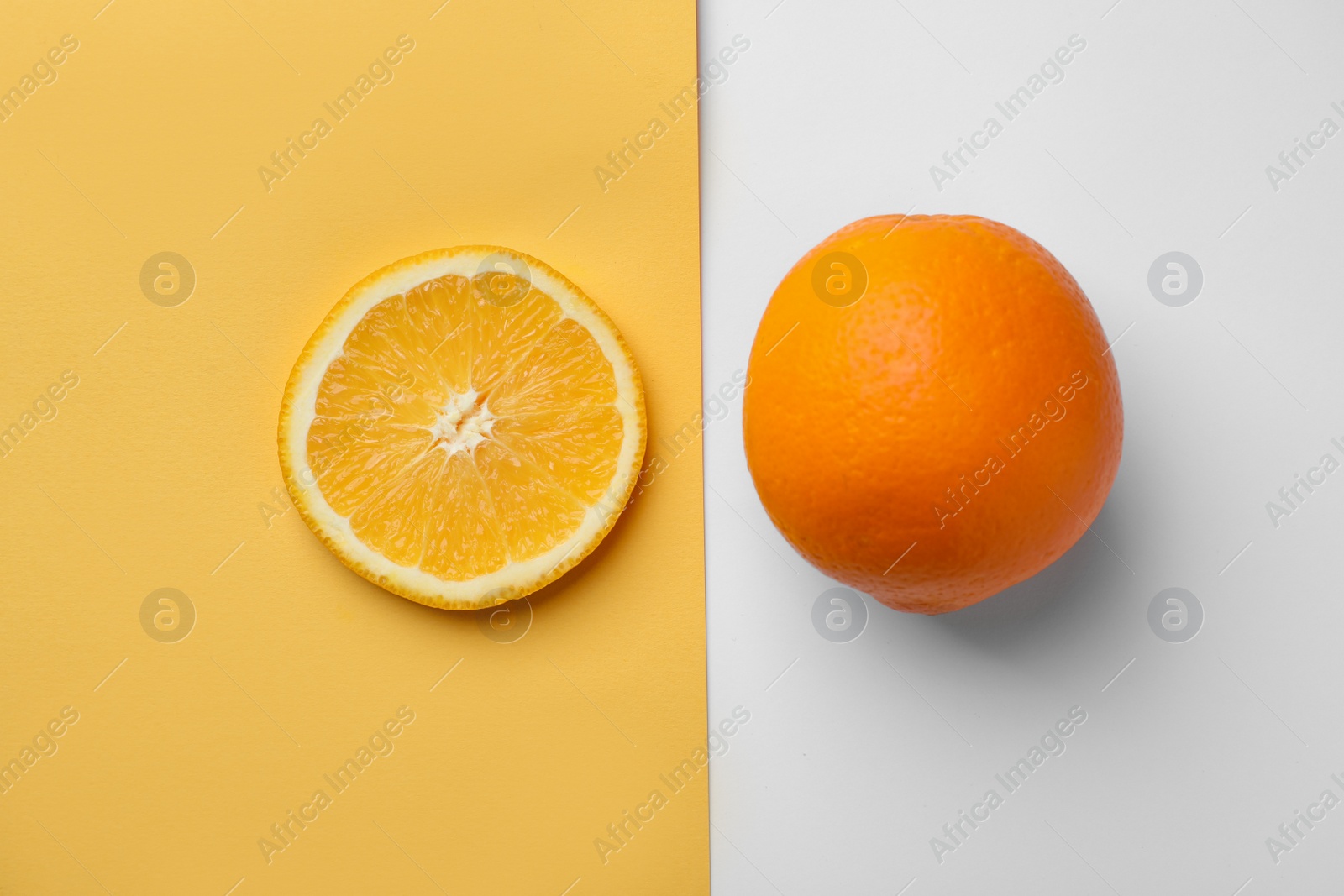 Photo of Fresh orange and slice on color background, top view