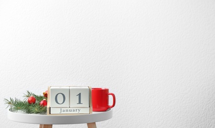 Wooden block calendar and festive decor on table. Christmas countdown