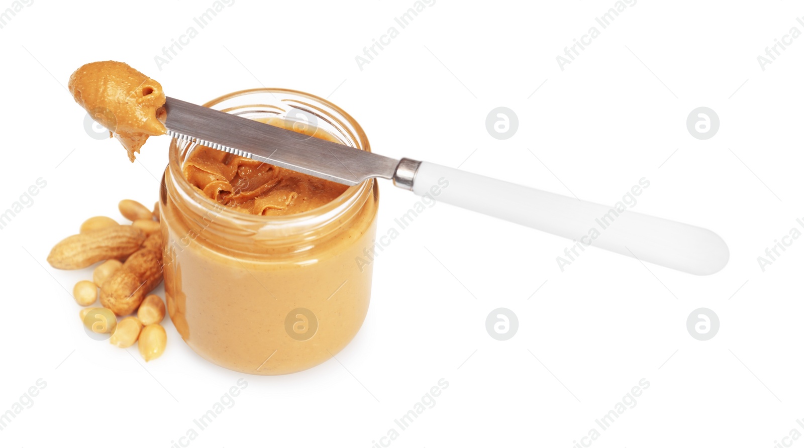 Photo of Tasty nut paste in jar, knife and peanuts isolated on white