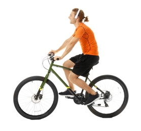 Photo of Happy young man with headphones riding bicycle on white background