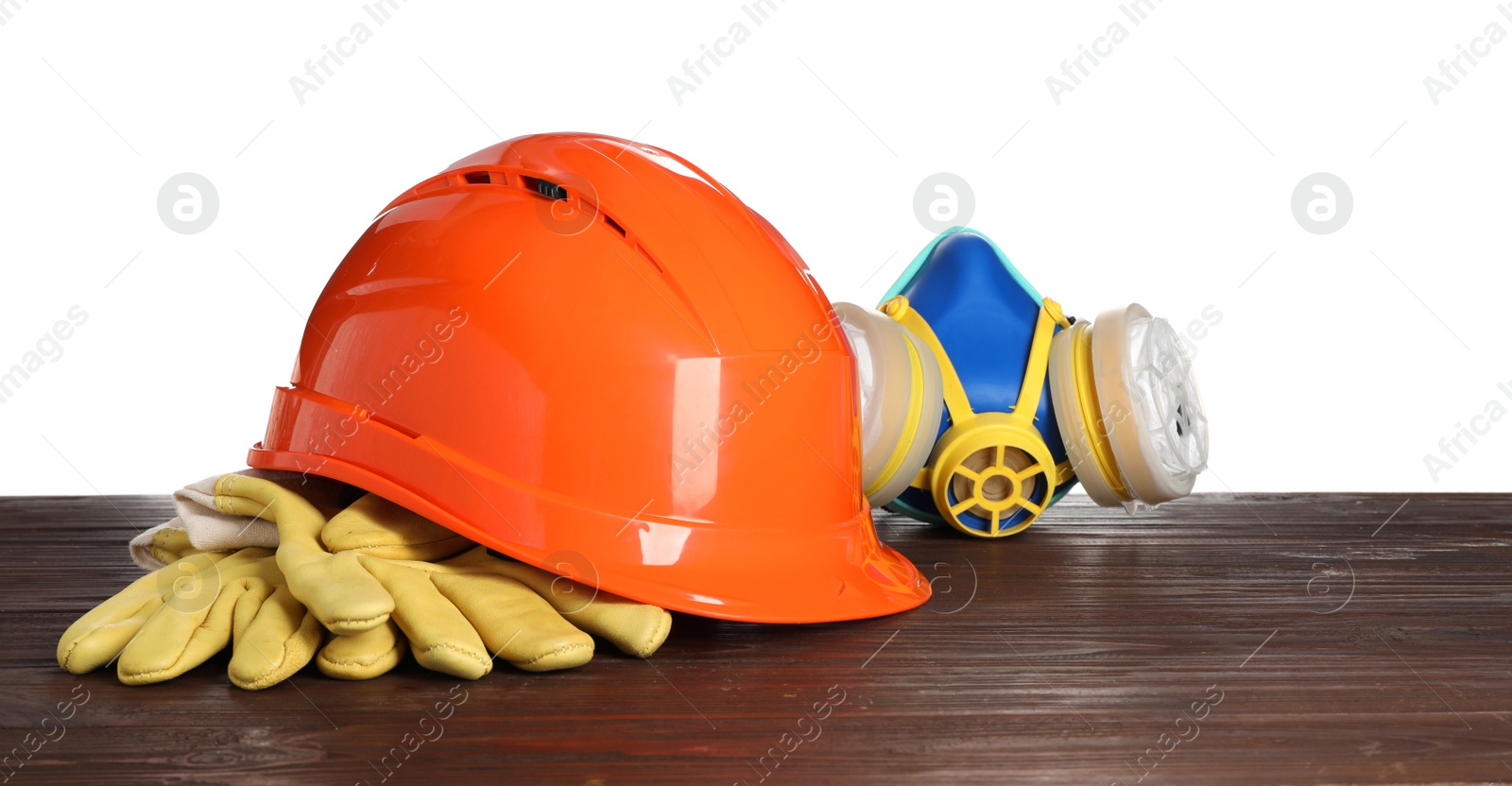 Photo of Personal protective equipment on wooden surface against white background