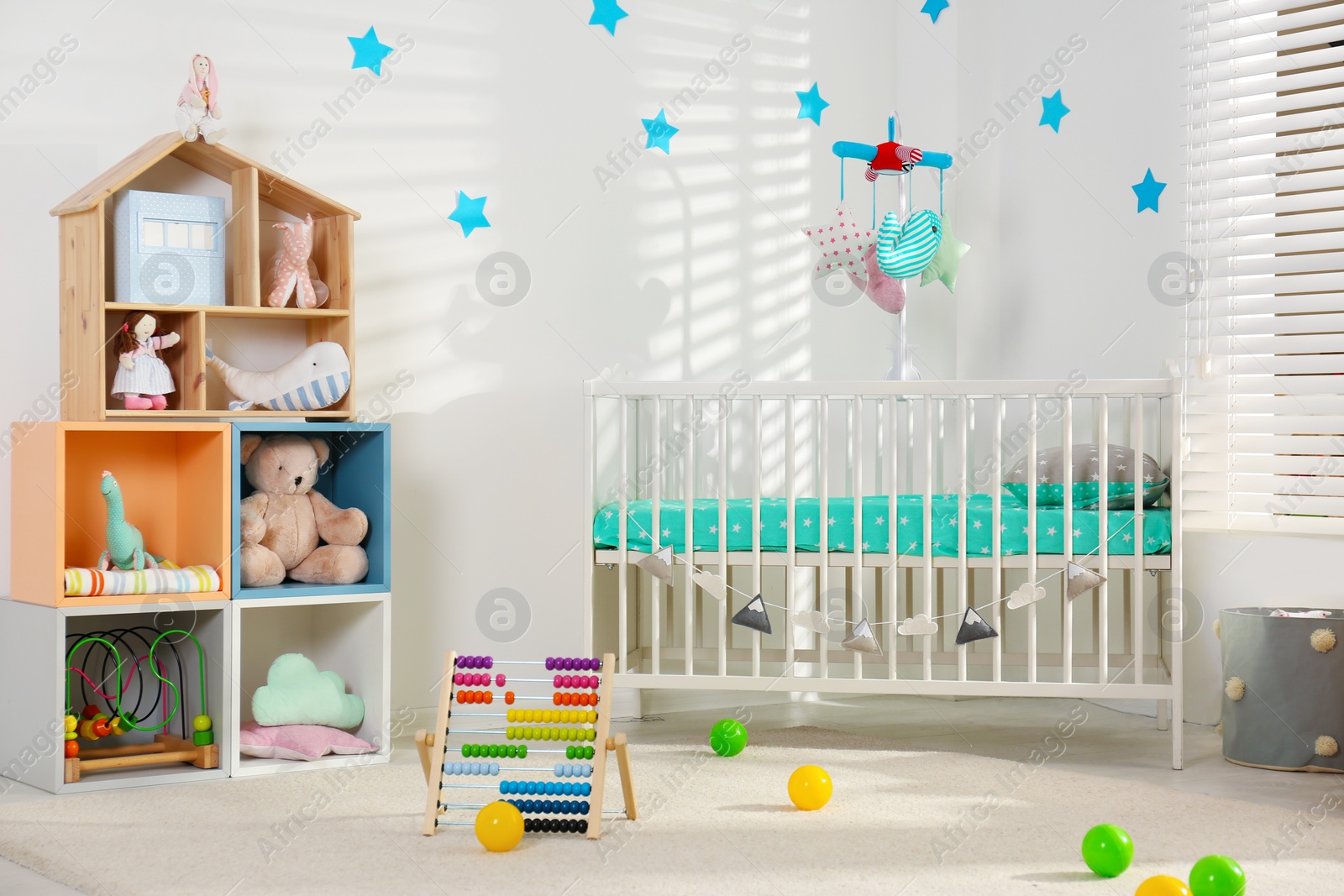 Photo of Cozy baby room interior with comfortable crib