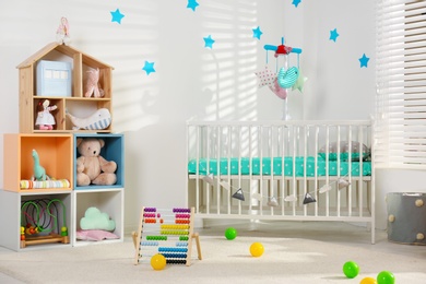 Cozy baby room interior with comfortable crib