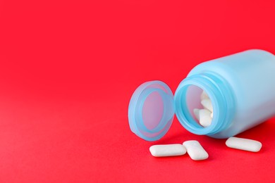 Jar with chewing gums on red background