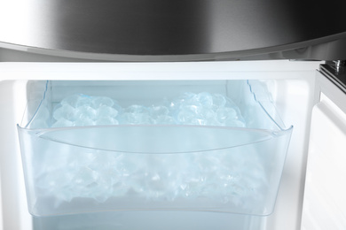 Photo of Plastic bags with ice cubes in fridge