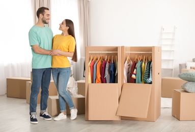 Young couple near wardrobe boxes at home