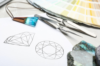 Photo of Drawing of gemstones on table, closeup. Designer's workplace