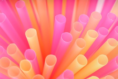 Heap of colorful plastic straws for drinks as background, closeup