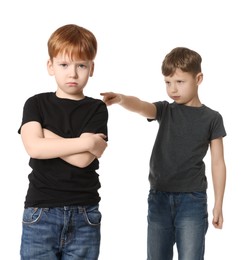 Photo of Boy pointing at upset kid on white background. Children's bullying