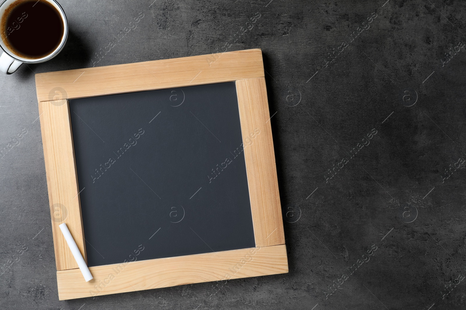 Photo of Clean small chalkboard and cup of coffee on grey table, flat lay. Space for text