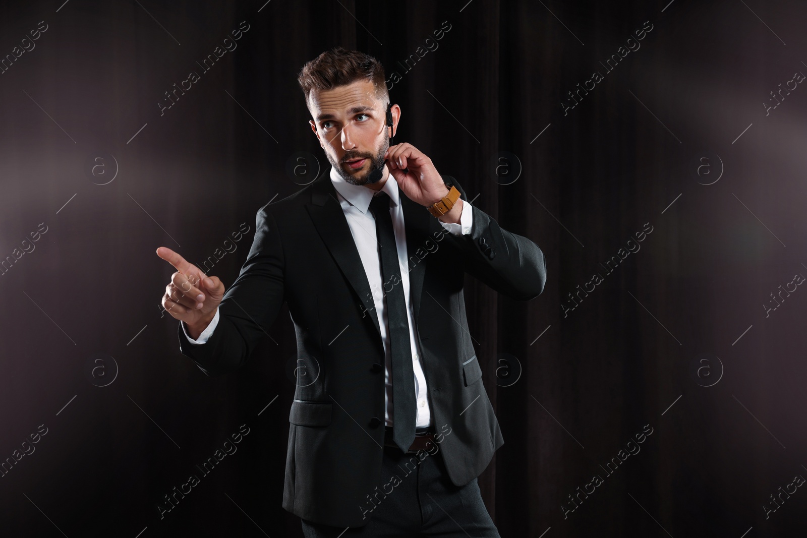 Photo of Motivational speaker with headset performing on stage