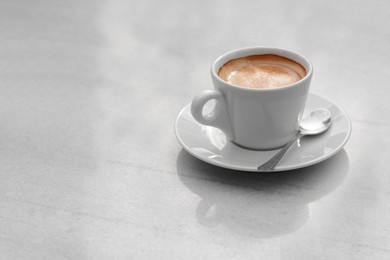 Ceramic cup of aromatic coffee on table in morning, space for text