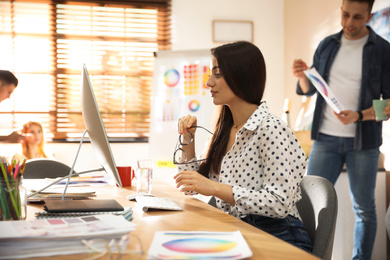 Female designer working with computer in office